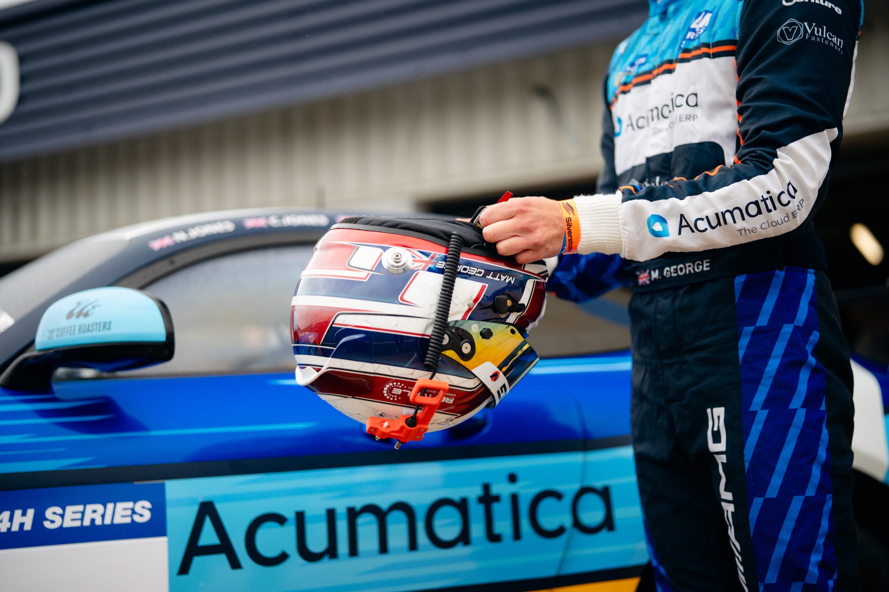 Venture Engineer racing car driver, with Acumatica sticker on car