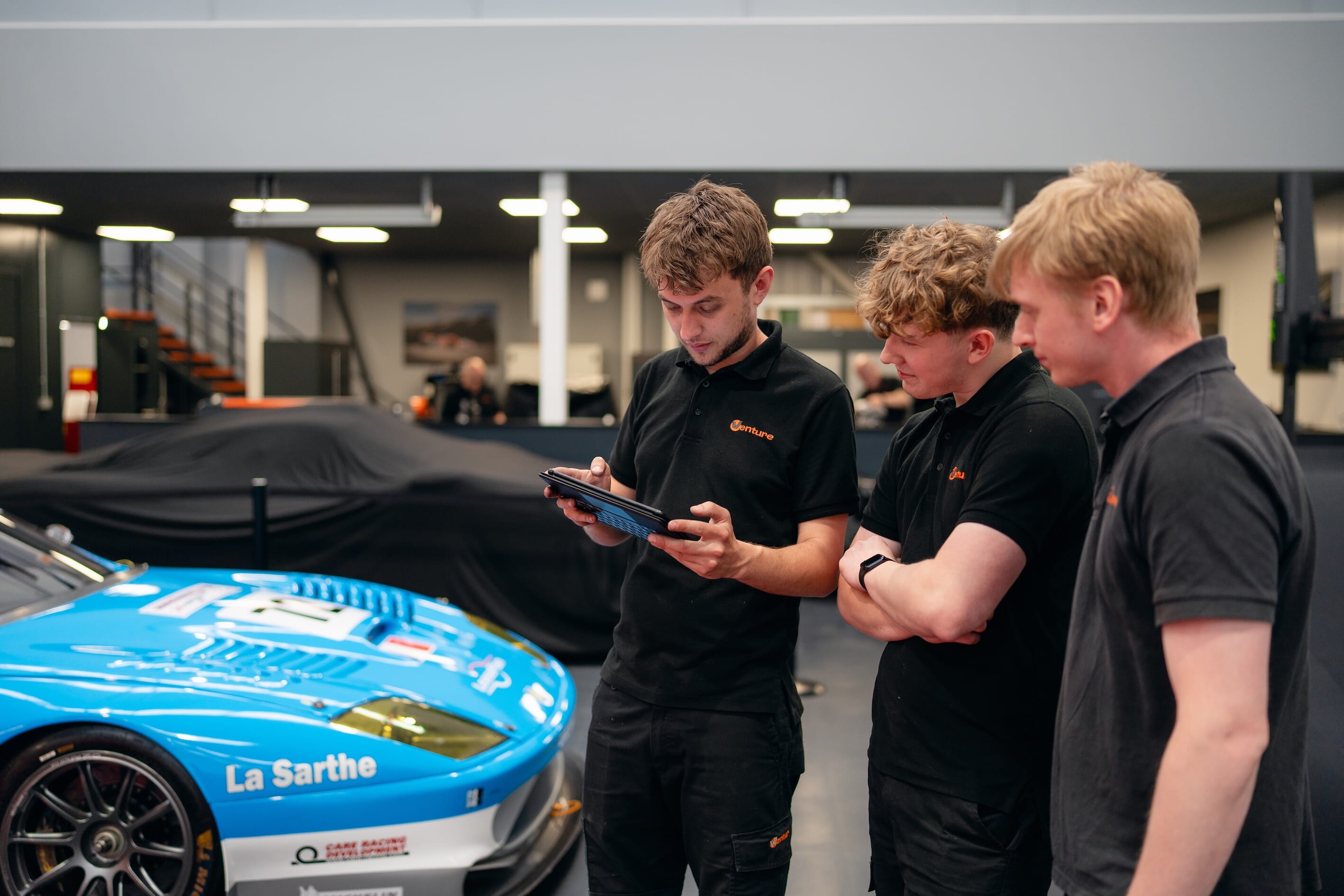 venture engineering staff looking at ipad